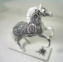Intricate black design on a white horse